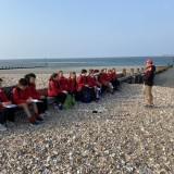 field trip pupils sitting on a groyne