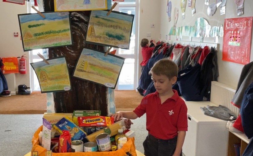 Pre-Prep boy making donation