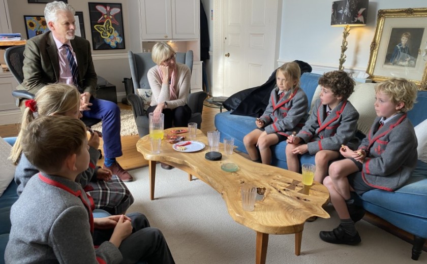 children having tea with the headmaster