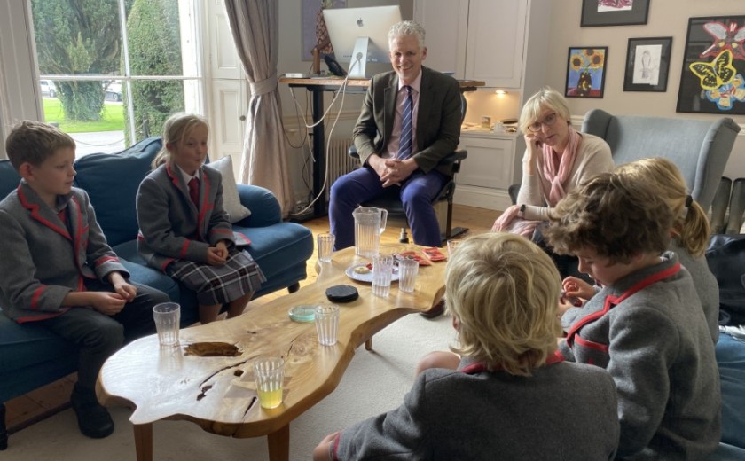 children having tea with the headmaster