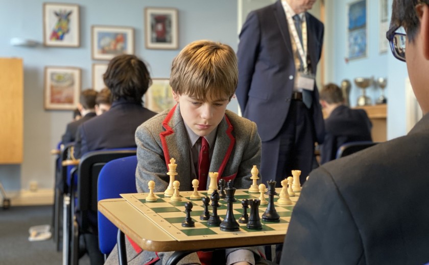 boy thinking and contemplating in chess