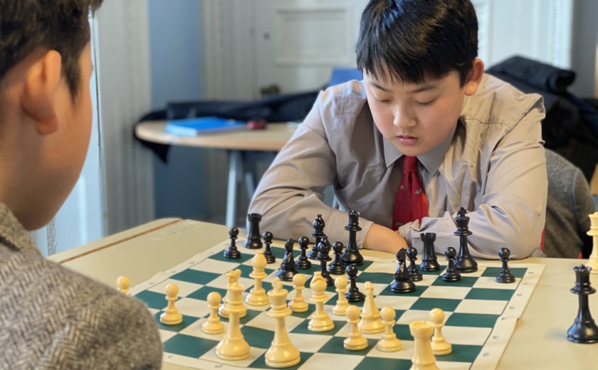 boy thinking and contemplating in chess