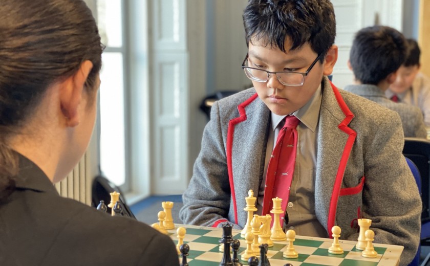 boy thinking and contemplating in chess