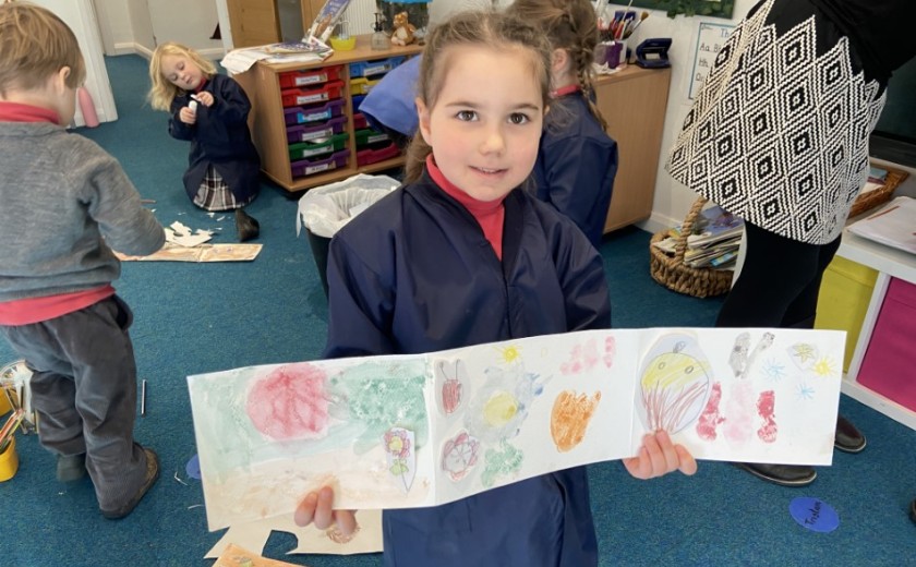 child shows drawing