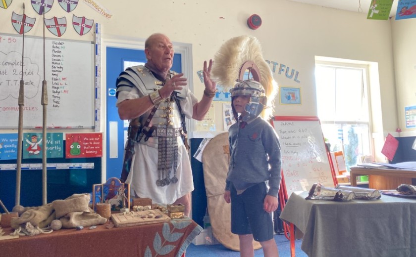 roman soldier in classroom showing things