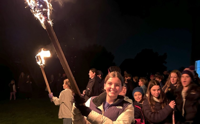 torch bearers light the bonfire